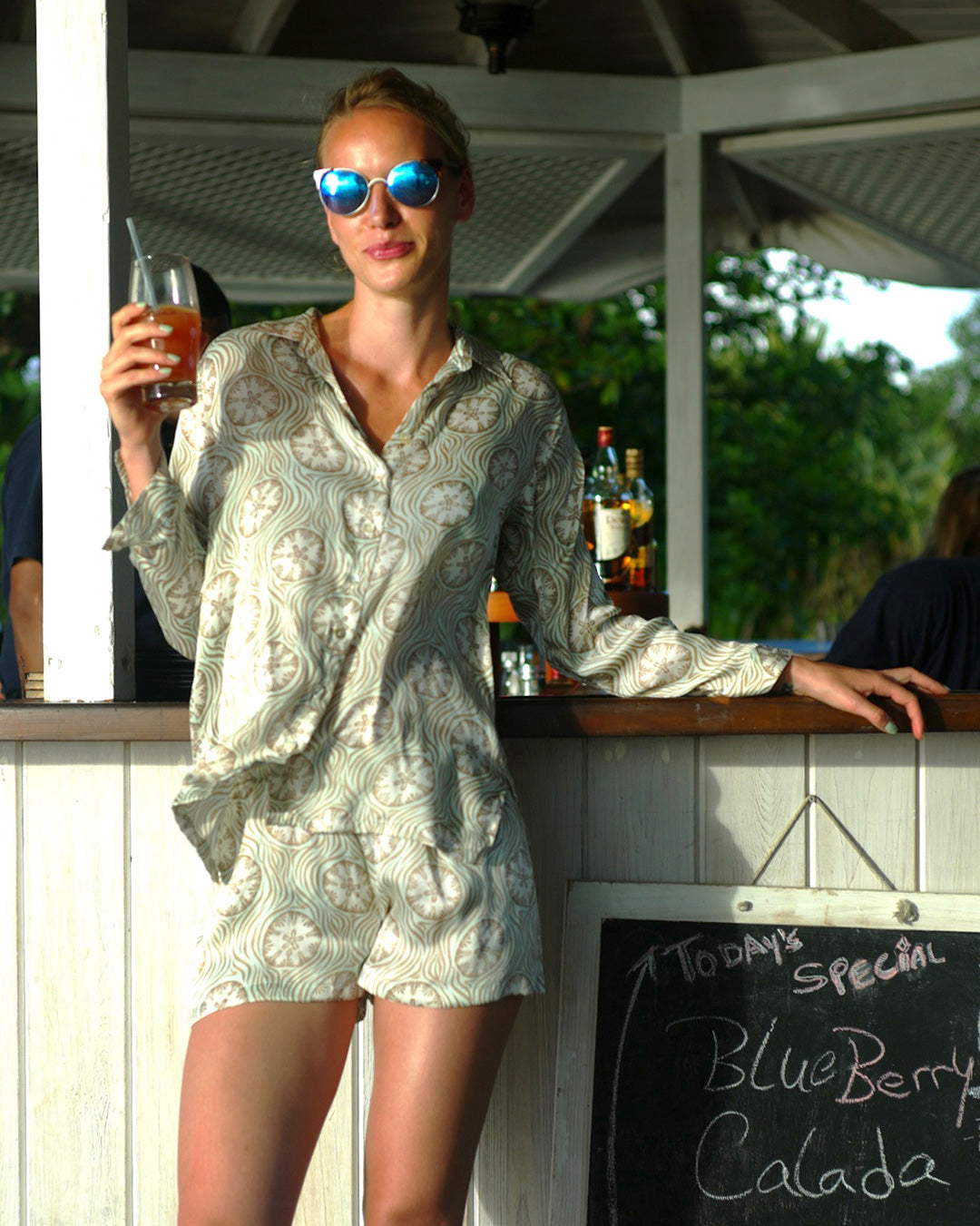 Cool casual Mustique style pure silk shirt in pale blue and taupe sand dollar print by resortwear designer Lotty B, Cotton House Beach Bar.