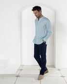 Casual linen trousers worn with pale blue linen shirt